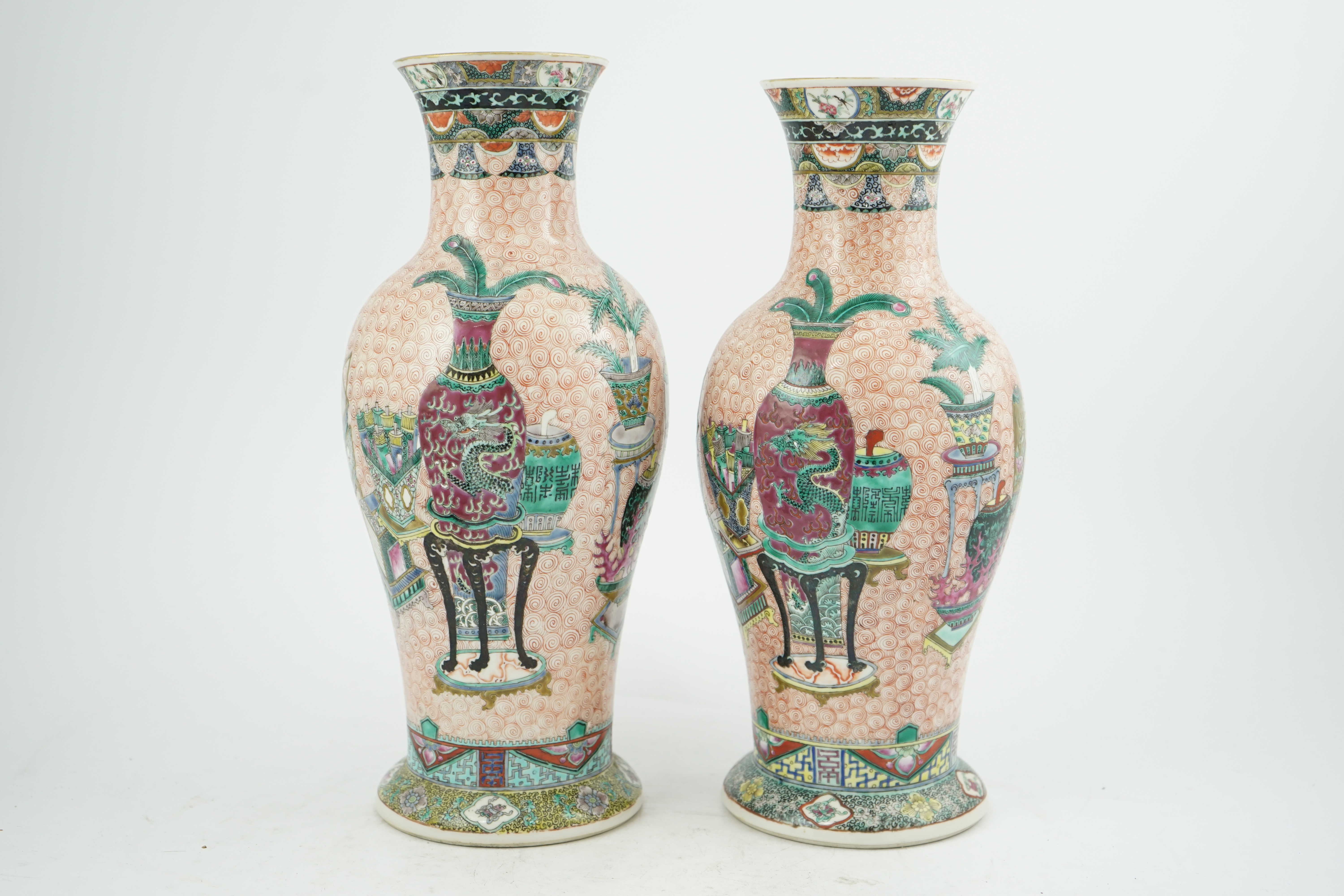 A near pair of Chinese famille rose ‘Hundred Antiques’ baluster vases, Kangxi mark, early 20th century